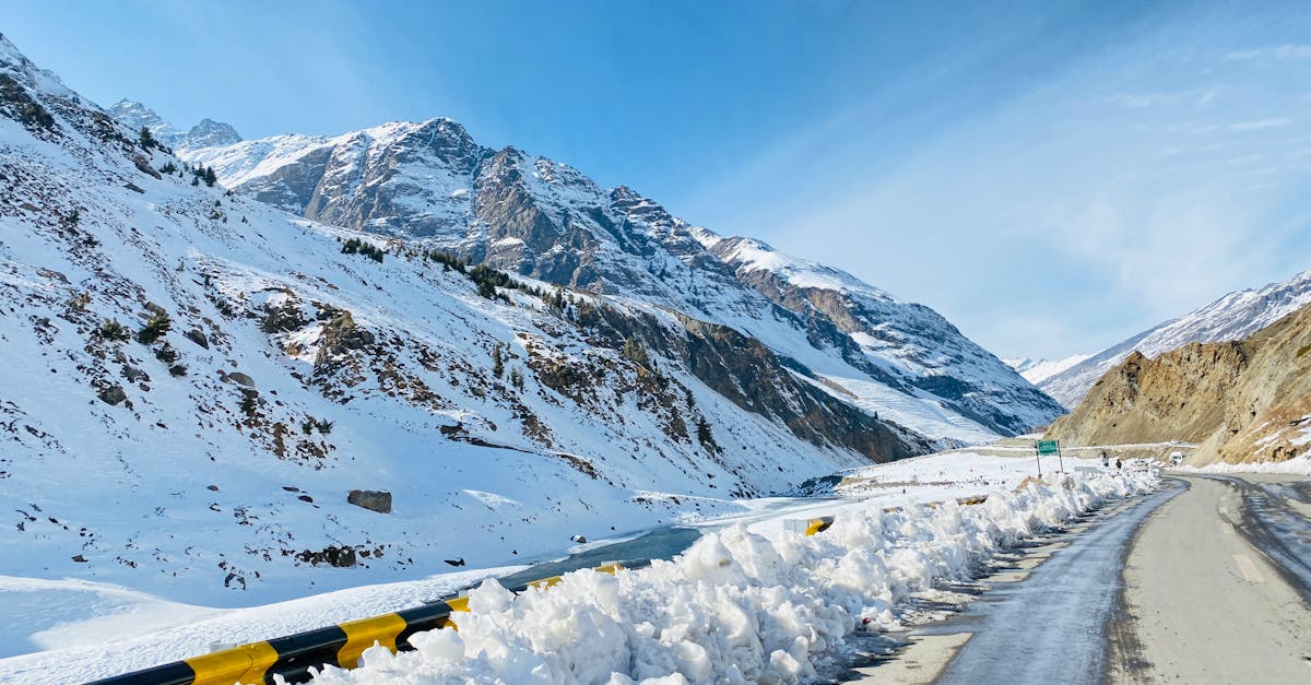 A stunning view of a snow-covered mountain road on a sunny winter day.