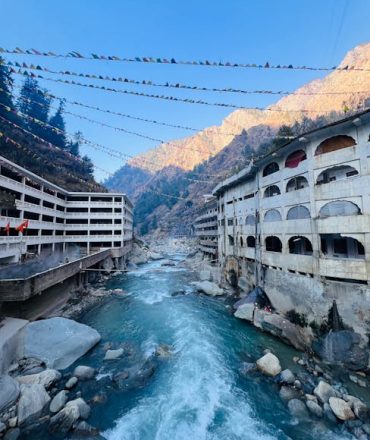 Beautiful river view with buildings and mountains in Manikaran, HP, India.