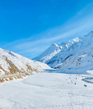 Beautiful winter landscape with snow-covered mountains and a frozen river.